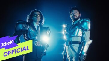 Dois homens em trajes futuristas de armadura, iluminados por luzes dramáticas em fundo escuro.