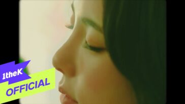 Close-up do perfil de uma mulher com olhos fechados, destacando sua pele e cabelo em um fundo suave.