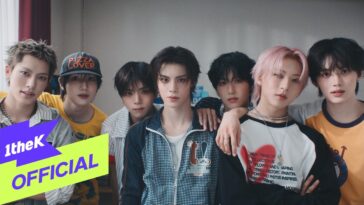 Sete jovens com estilos variados, posando juntos em um ambiente interno, com expressões descontraídas.